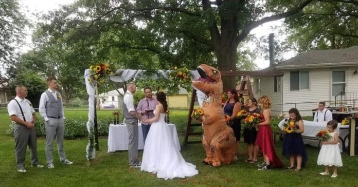 Dama de honor surpreende todos ao vestir-se de dinossauro no casamento da irmã