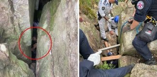 Mulher fica pendurada de cabeça para baixo entre duas pedras enormes ao tentar recuperar celular caído